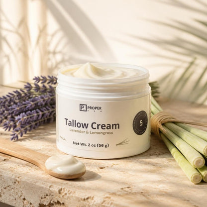 Proper Lavender Lemongrass Tallow Cream on a stone ledge with lavender and lemongrass