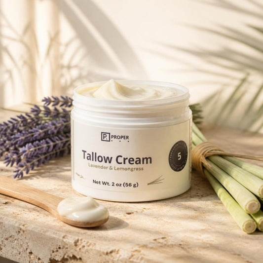 Proper Lavender Lemongrass Tallow Cream on a stone ledge with lavender and lemongrass