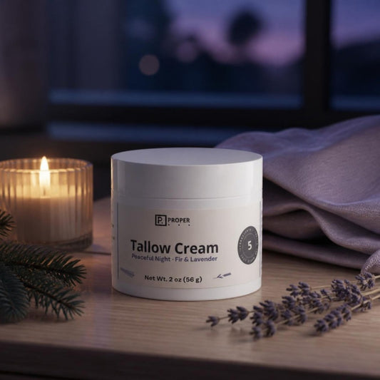 Proper Peaceful Night Tallow Cream on a nightstand with candle, fir and lavender